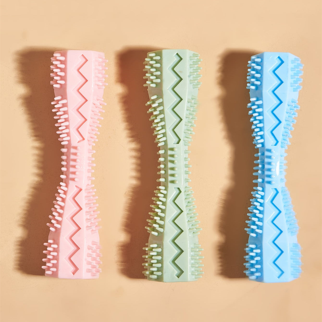 Chew toys set in pink, green, and blue with textured bristle strips