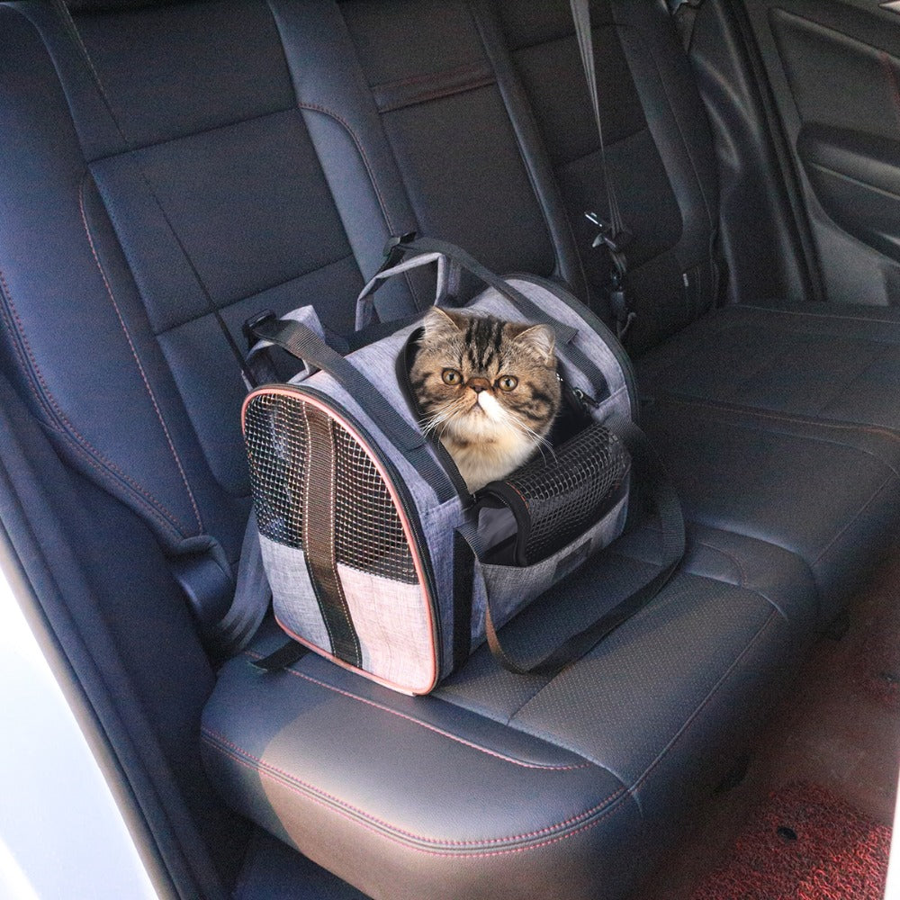 Folding pet carrier bag with front mesh window, cat sitting inside on car seat