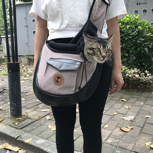 Grey Pet travel bag: black shoulder carrier with striped front pocket, cat inside