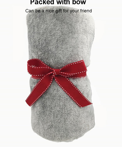 Grey flannel blanket wrapped and tied with a red gift bow