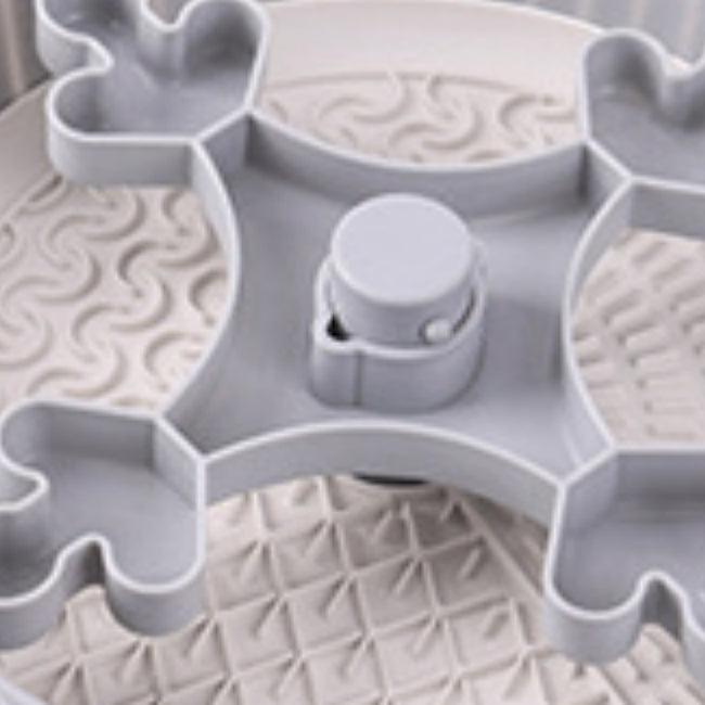 Interior of gray rotating feeder with textured slow-eating surface and spinner