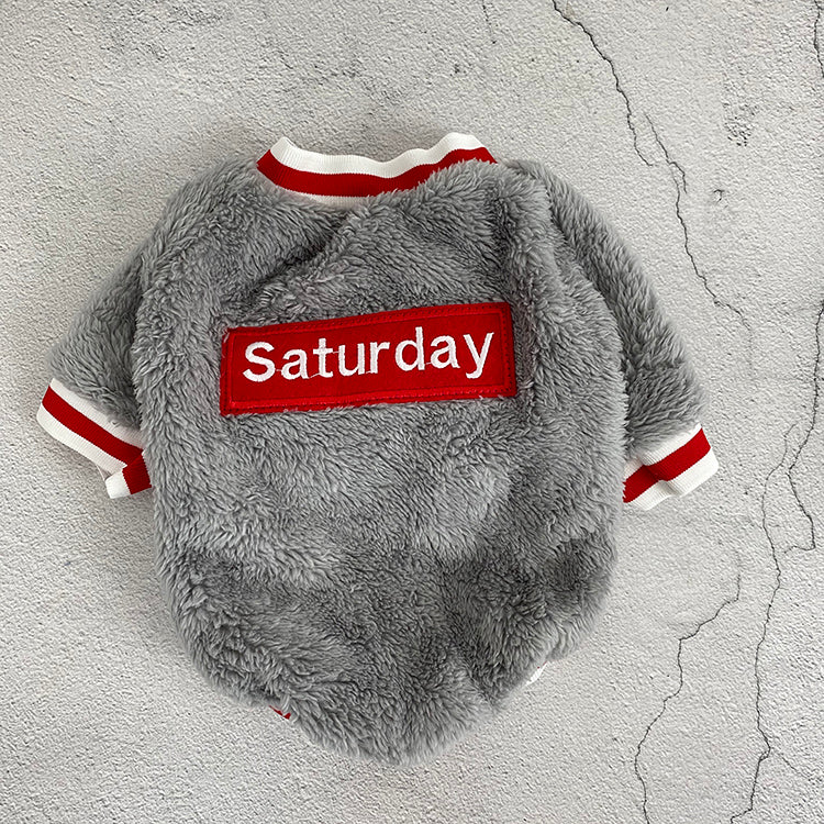 Blue-gray plush pet sweater back view with red “Saturday” patch