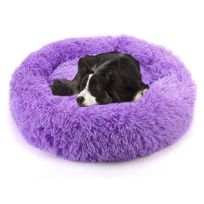 Purple plush round pet bed with dog resting inside
