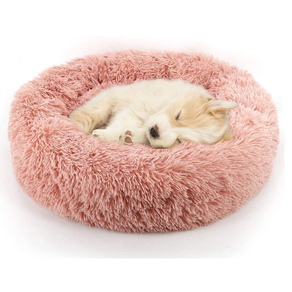 Light pink round plush pet bed with shag cushion and bolster