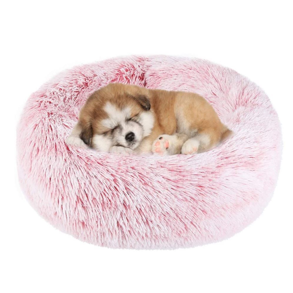 Pink plush round pet bed with two puppies sleeping inside