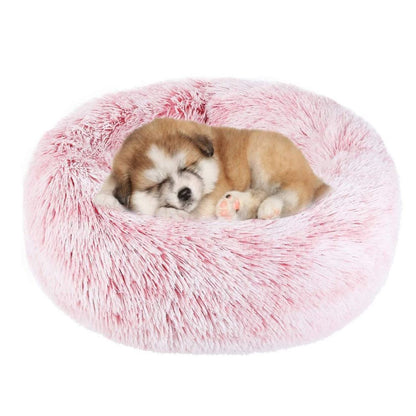 Pink plush round pet bed with two puppies sleeping inside