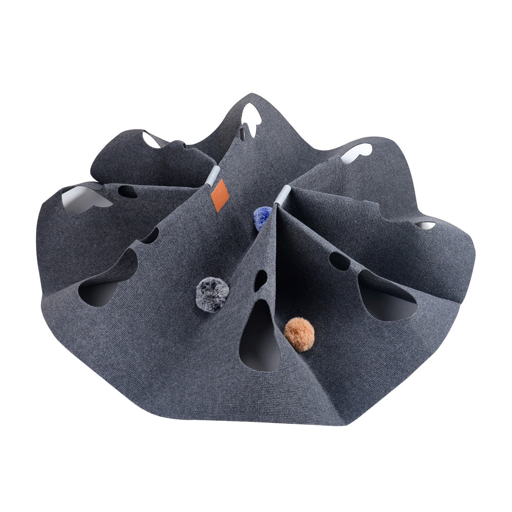 Grey square cat tunnel blanket with paw-shaped cutouts and felt balls