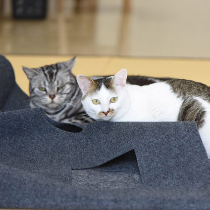 Grey square cat hole blanket with cat peeking from side openings