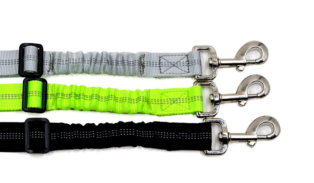Reflective dog car seat belt straps in grey, neon green, and black with metal hooks.
