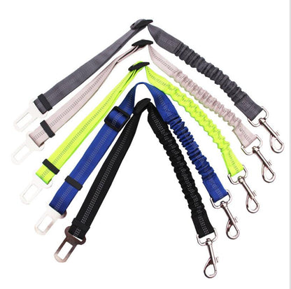 Set of adjustable reflective dog car seat belts with grey, neon green, blue, and black straps.
