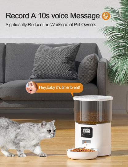 White automatic pet feeder near a cat with food in the dispensing bowl