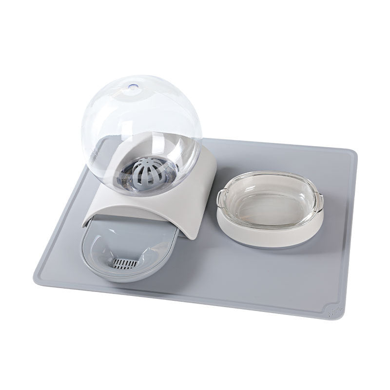 Pet feeding waterer set on grey mat with water globe, dish, and clear bowl