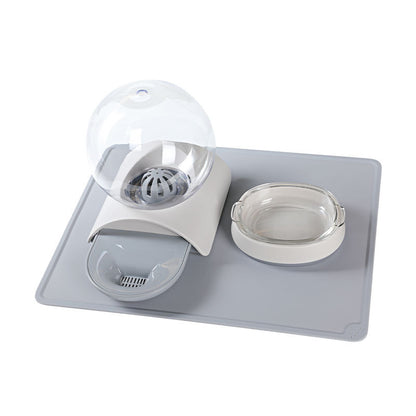 Pet feeding waterer set on grey mat with water globe, dish, and clear bowl