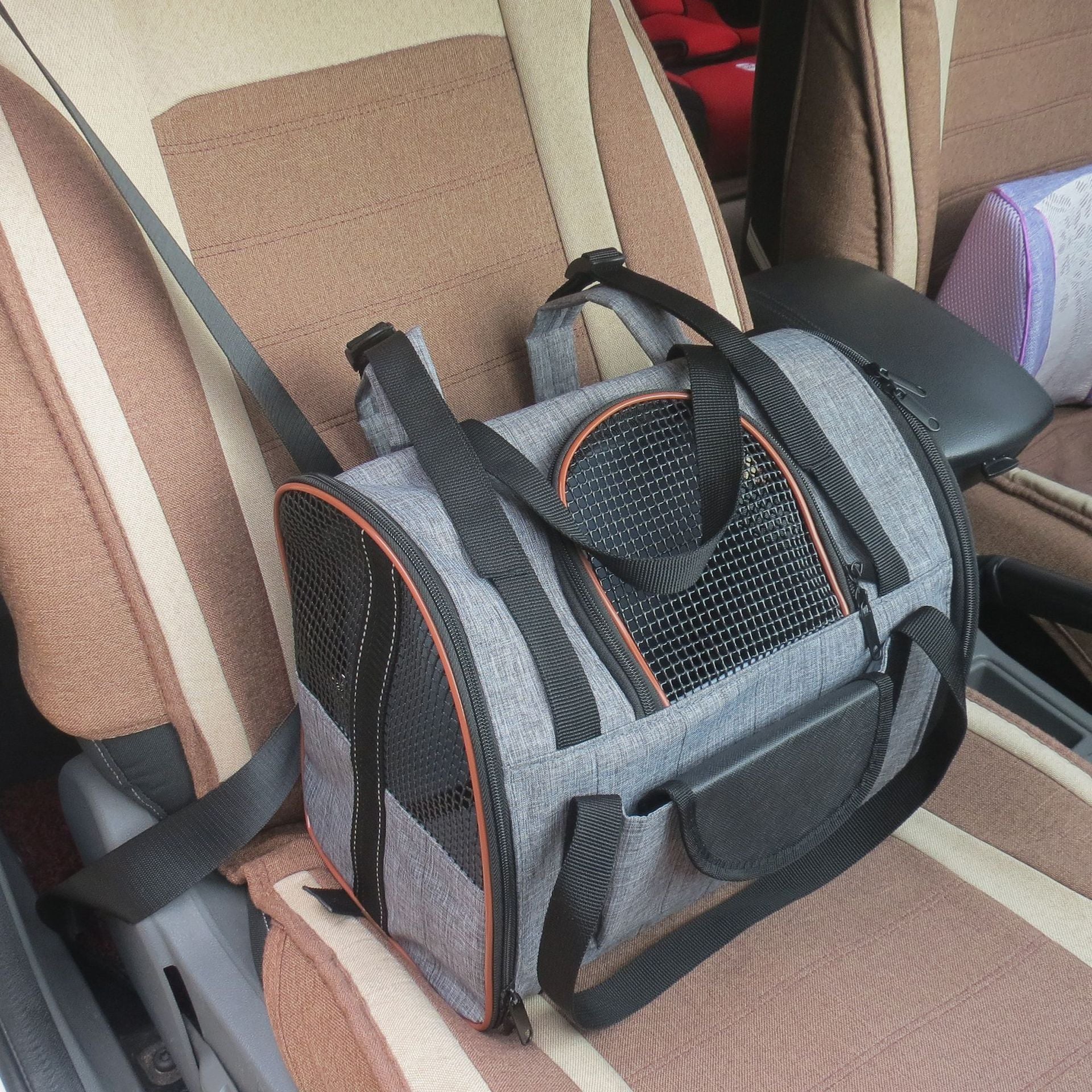 Grey folding pet car seat carrier with orange trim, mesh doors and safety straps