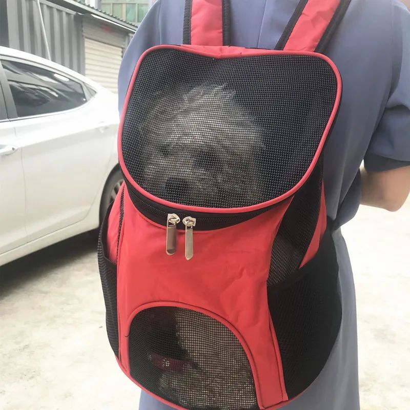 Red and black puppy carrier backpack with large front mesh panel and zip top
