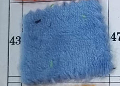 Flannel pet blanket swatch, light blue fuzzy texture