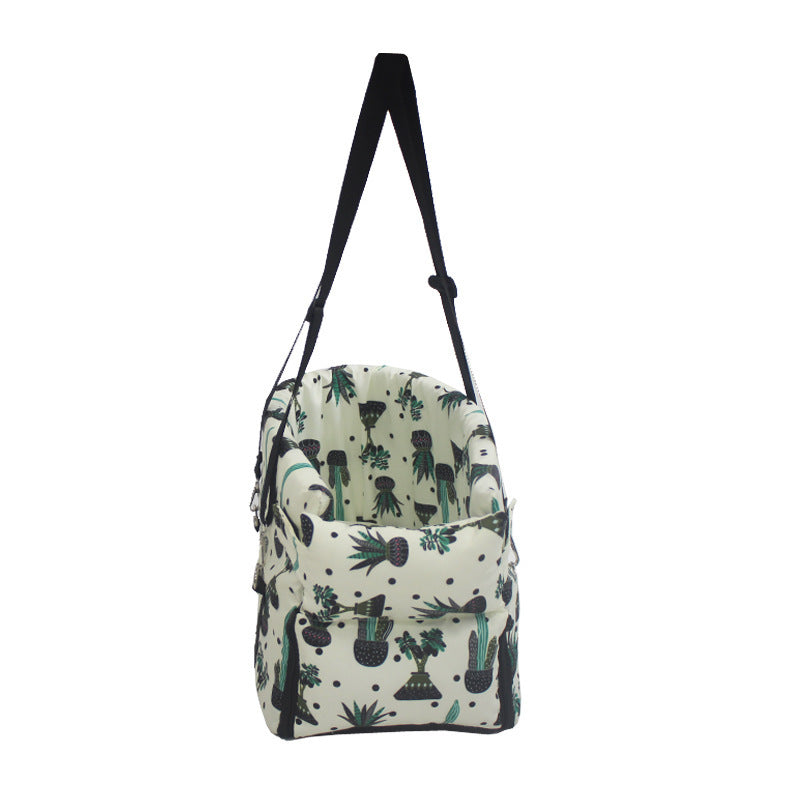Car pet bed with plant-pattern fabric and black carry straps, zippered sides