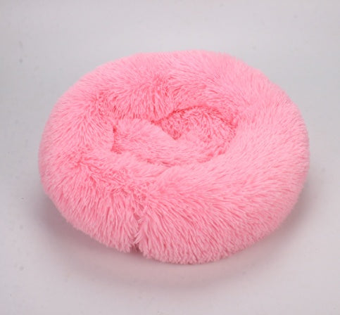 Pink plush round pet bed with raised inner rim