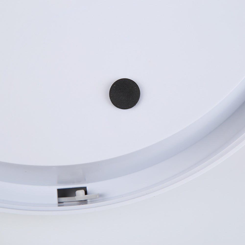 White feeder lid underside with central black sensor port