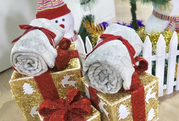 Grey flannel wrapped blanket rolls with red bows