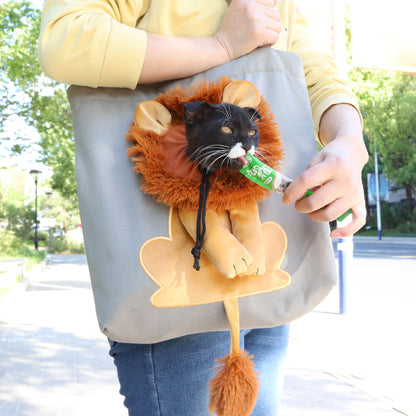 Light grey pet carrier tote with lion face plush graphic and dangling tassel