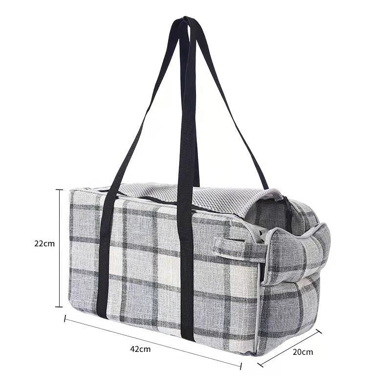 Plaid pet tote carrier with black handles and front buckle at the foldover edge