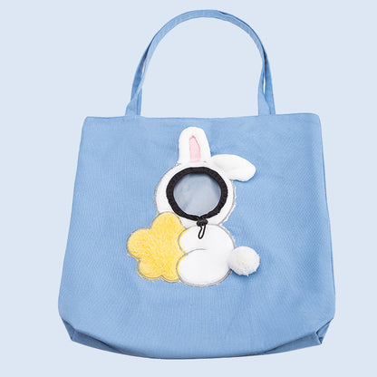 Blue pet carrier tote bag front view with plush animal face and round opening