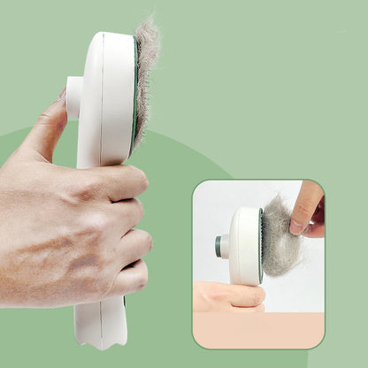 Handheld pet hair comb removing fur from brush pad, white body with dark green edge