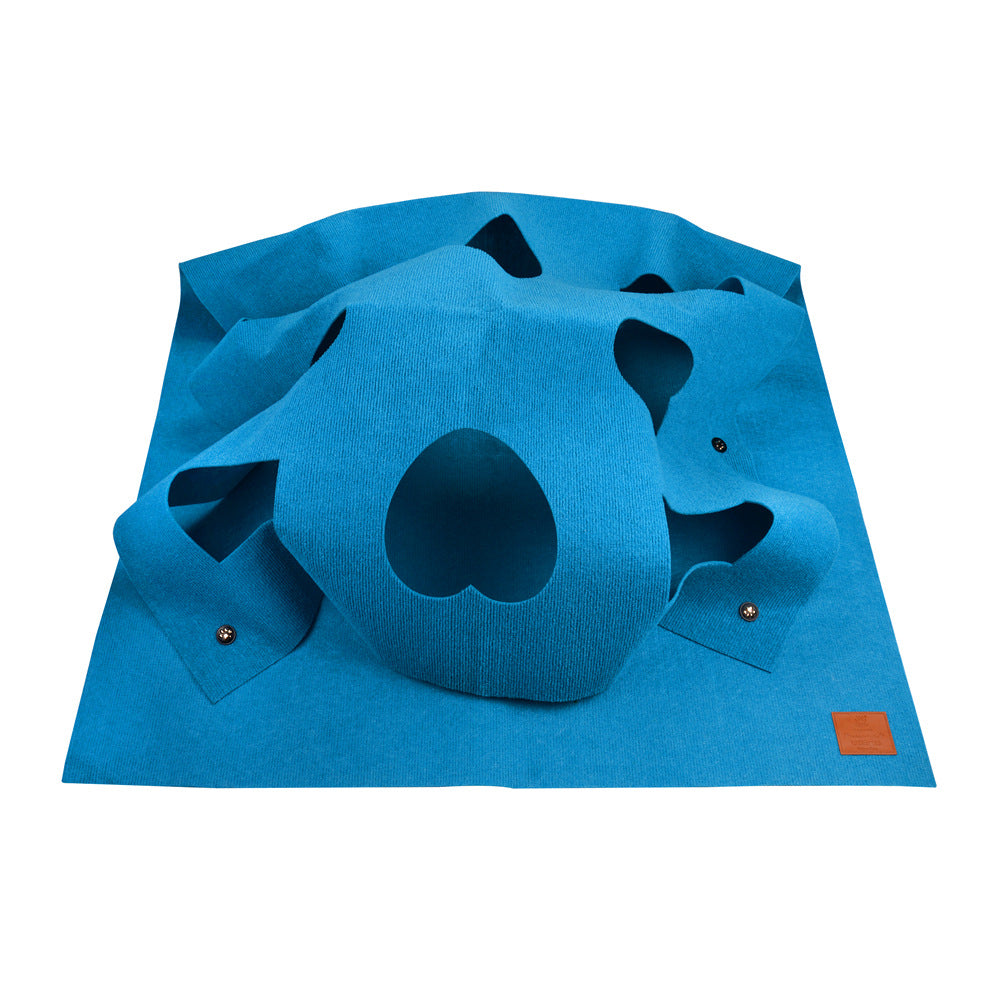 Blue square cat hole blanket with large paw cutouts and hanging toys
