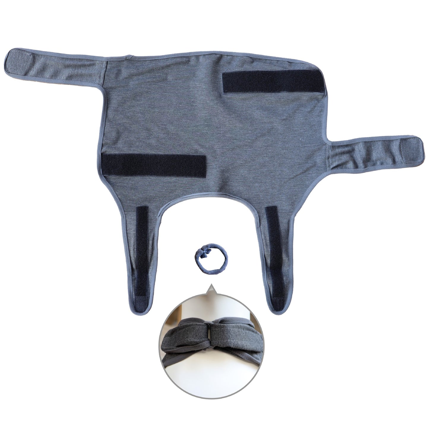 Flat view dog anxiety vest, dark gray fabric with front Velcro straps and leg openings