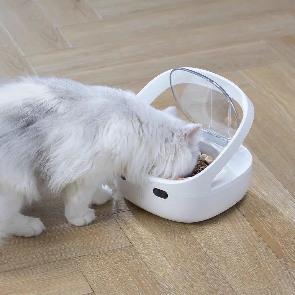 White smart pet feeder with transparent anti-theft cover, filled with kibble