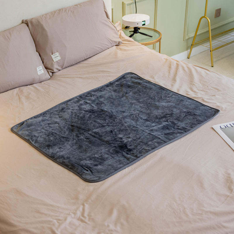 Navy blue fluffy waterproof pet blanket with dark edge trim, flat on bed
