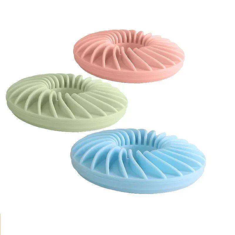 TPR slow-feeding frisbee in pink and green, with ridged treat grooves