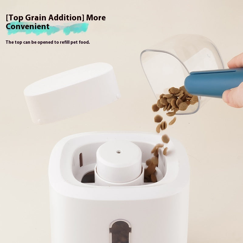 Pet feeder top refill area with chute; kibble being added
