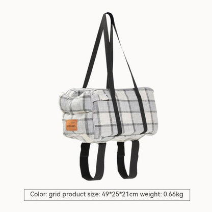 Plaid pet travel tote hanging with black straps and padded carry frame