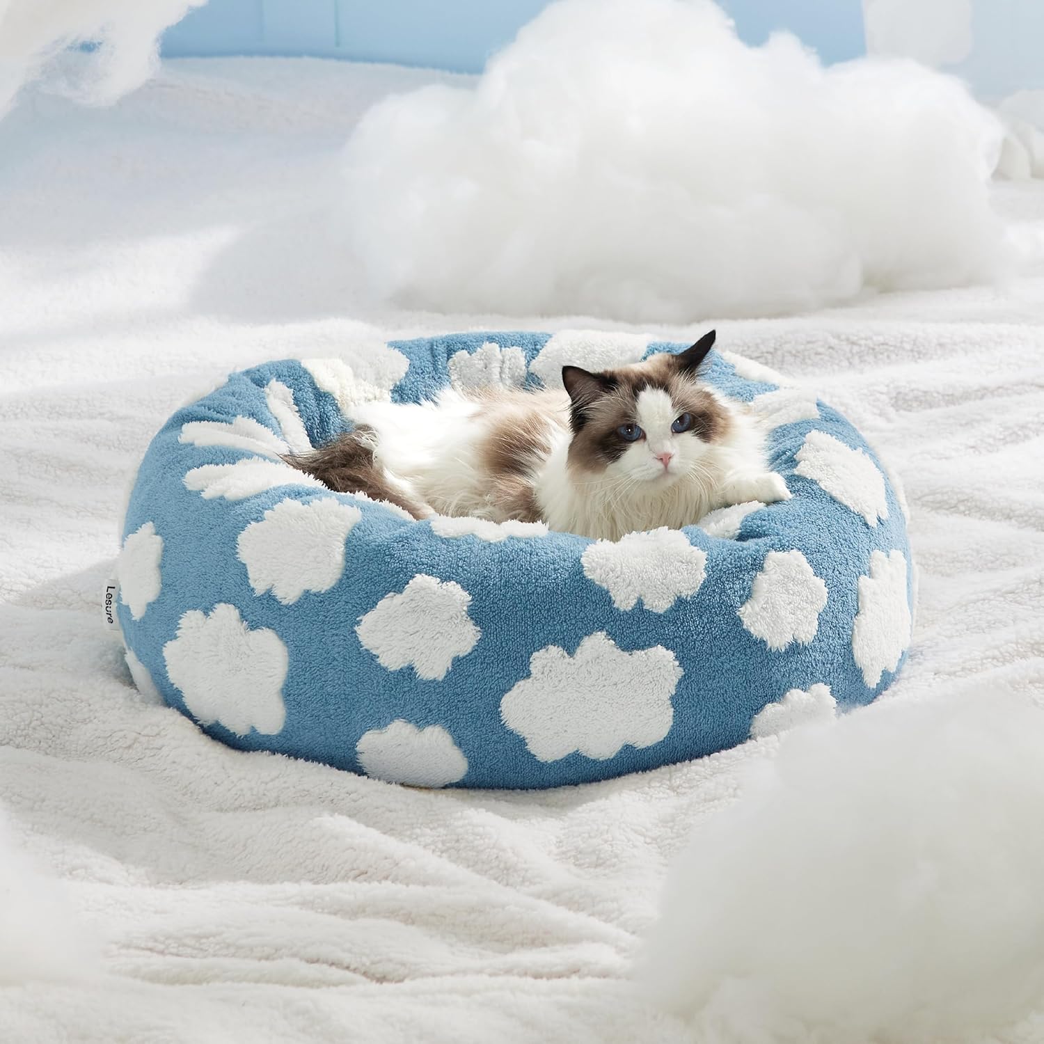 Blue round plush pet bed with white flower spots, donut shape cushion