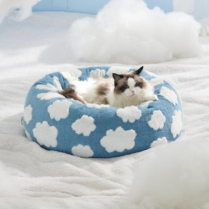 Blue round plush pet bed with white flower spots, donut shape cushion