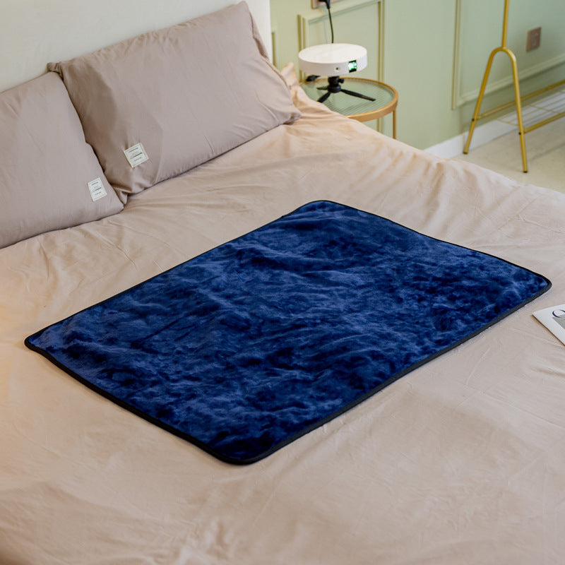 Navy blue fluffy waterproof pet blanket with dark edge trim on bed surface