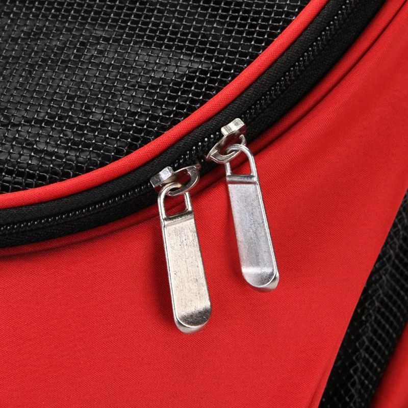 Red puppy carrier backpack close-up of front mesh panel and zipper pull loops