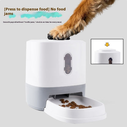 Gray & white pet feeder with press dispenser opening and food tray filled