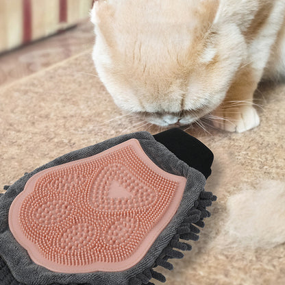 Pink silicone grooming brush glove on gray chenille for bathing, brushing, massage